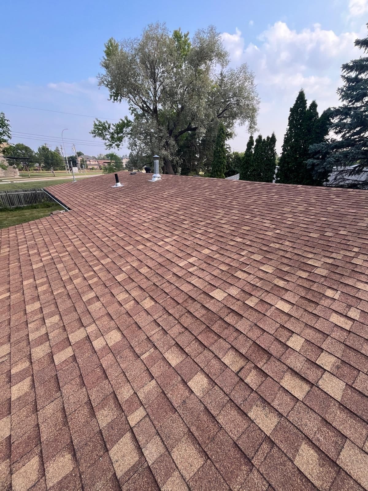 Completed terracotta-red shingle roof